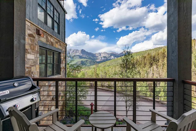 a view of a chairs and table in a balcony
