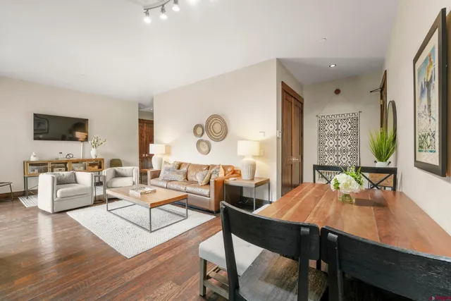 a view of a dining room with furniture and wooden floor
