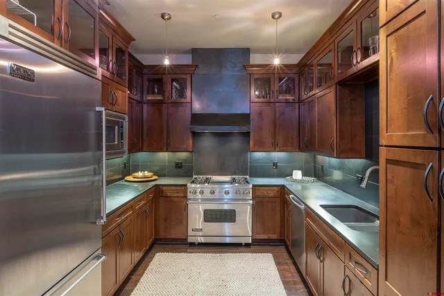 a kitchen that has a sink and a stove