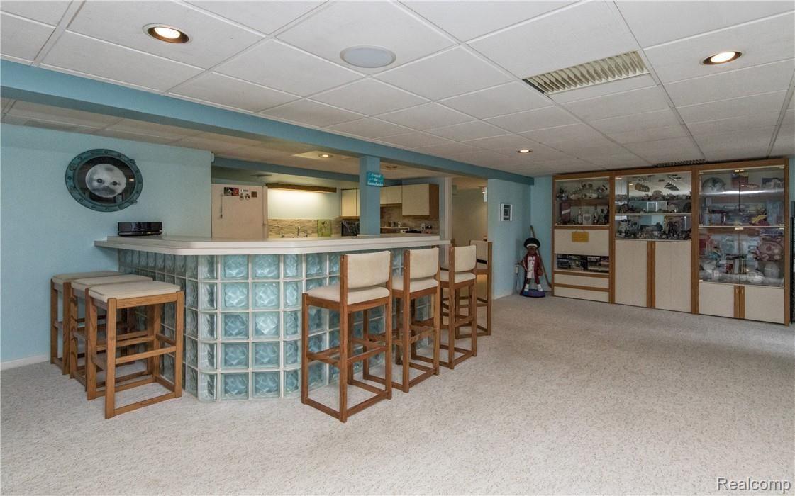 7272 Hatchery Road Waterford, MI 48327 - Photo 25 of 46 Very open and spacious lower level with wrap around bar, full kitchen, and ample storage space!