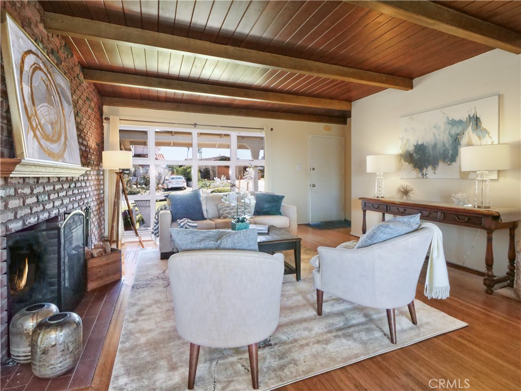 156 Vía Los Altos Redondo Beach, CA 90277 - Photo 4 of 25 a living room with furniture a fireplace and a table