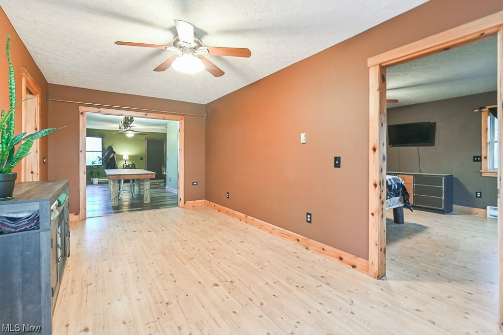 4802 Beach Road Medina, OH 44256 - Photo 16 of 35 Living room with light wood-type flooring, ceiling fan, and a textured ceiling