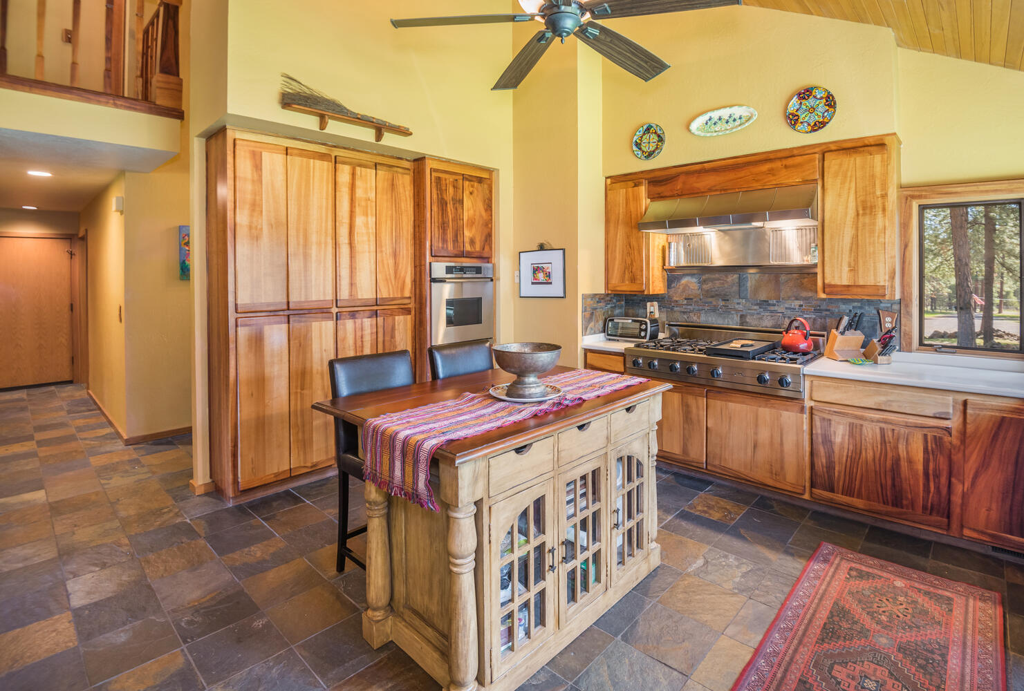 67895 Peterson Burn Road Sisters, OR 97759 - Photo 9 of 63 Chef's kitchen with Koa wood cabinetry, Viking 6-burner + griddle range, commercial hood, oven, and more