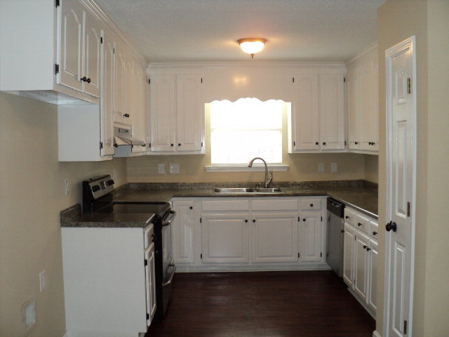 169 Pea Ridge Road Juliette, GA 31046 - Photo 2 of 12 a kitchen with granite countertop white cabinets sink and window
