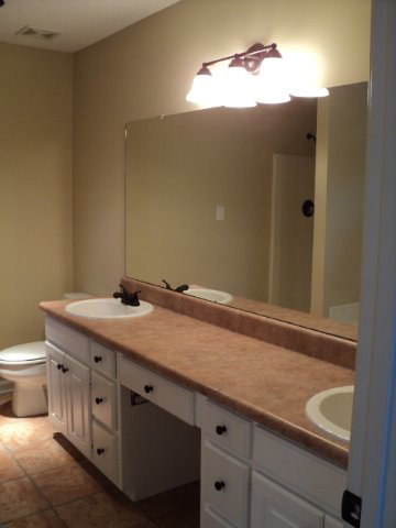 169 Pea Ridge Road Juliette, GA 31046 - Photo 5 of 12 a bathroom with a granite countertop sink and a mirror