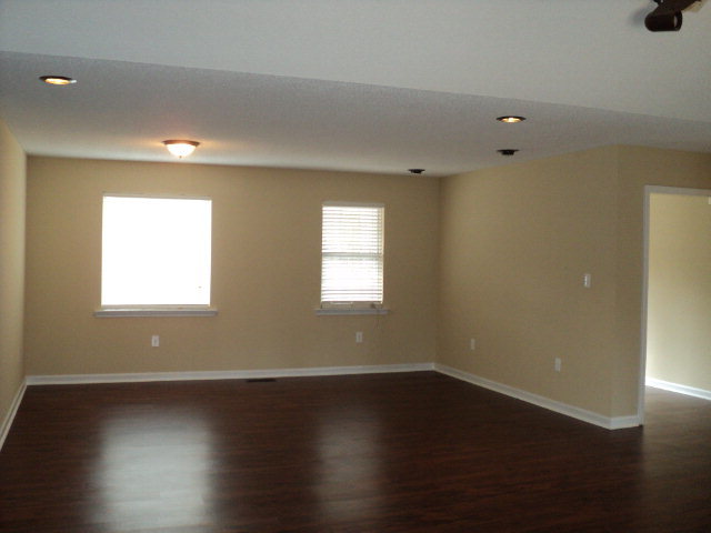 169 Pea Ridge Road Juliette, GA 31046 - Photo 6 of 12 an empty room with wooden floor and windows