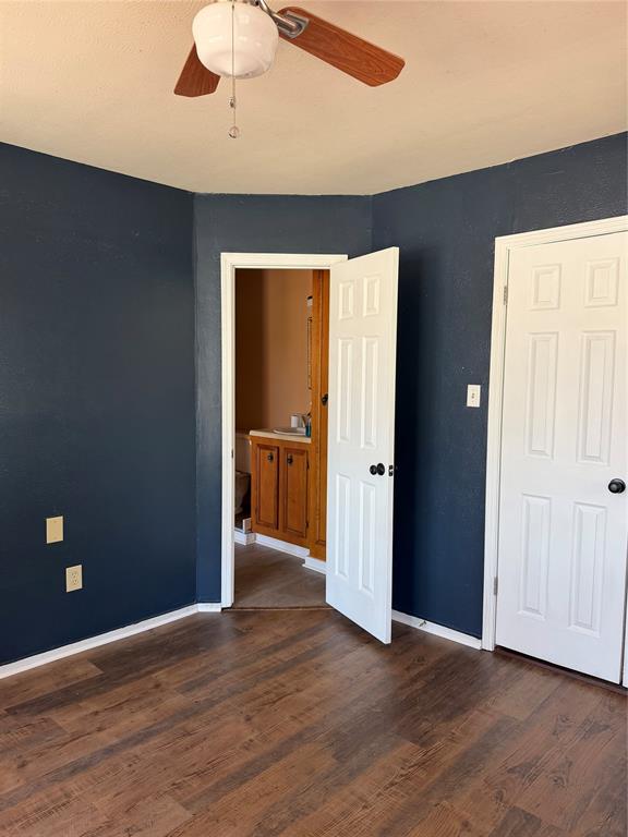 263 Highway 154 Ringgold, LA 71068 - Photo 14 of 38 Unfurnished first floor bedroom featuring dark wood-style flooring and ceiling fan
