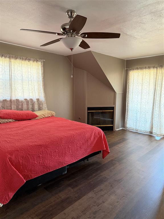 263 Highway 154 Ringgold, LA 71068 - Photo 18 of 38 Bedroom featuring a textured ceiling, dark wood-style floors, and ceiling fan