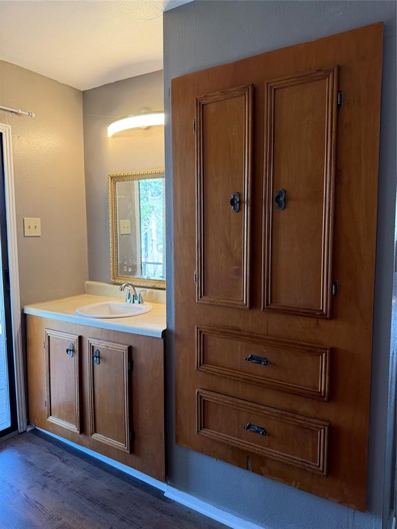 263 Highway 154 Ringgold, LA 71068 - Photo 20 of 38 Bathroom featuring vanity and dark wood-style floors