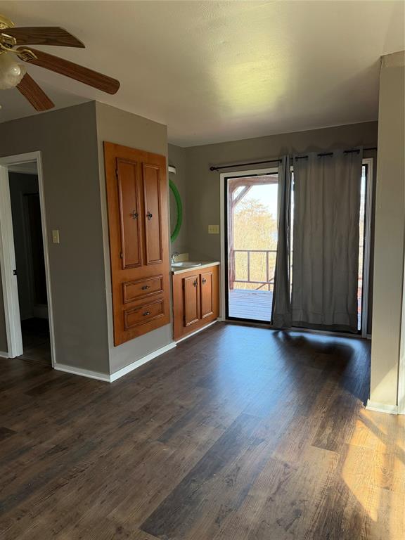 263 Highway 154 Ringgold, LA 71068 - Photo 26 of 38 Unfurnished dining area with dark wood-type flooring and a ceiling fan