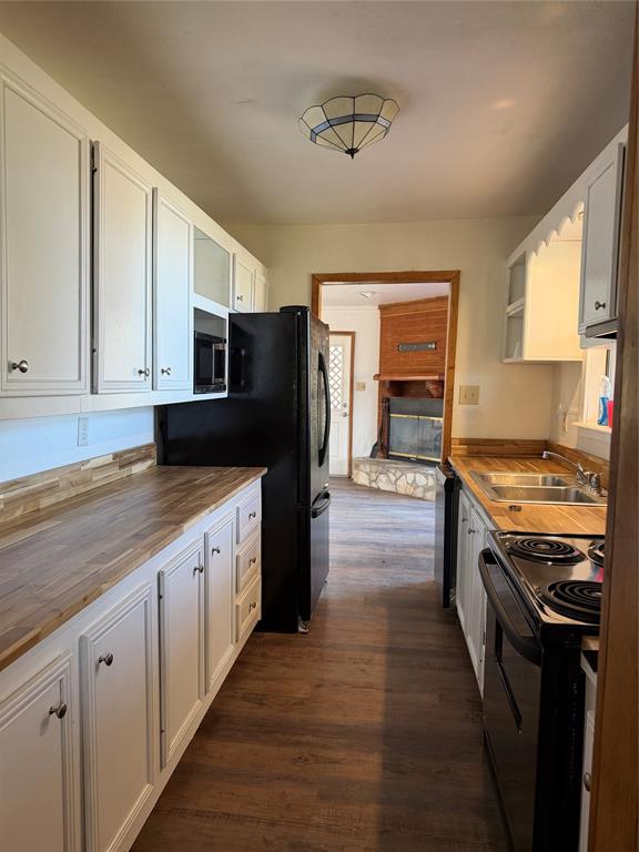 263 Highway 154 Ringgold, LA 71068 - Photo 10 of 38 Kitchen featuring butcher block countertops, white cabinetry, black and stainless appliances