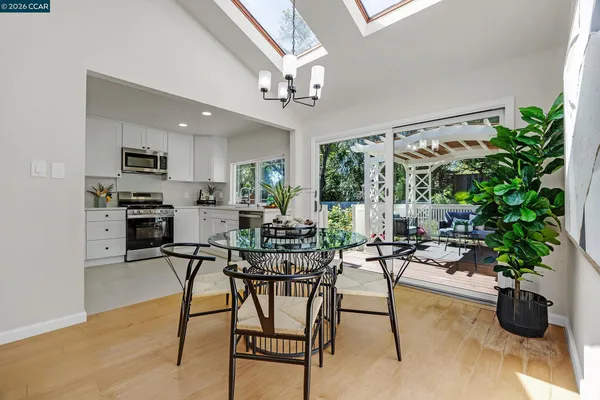 a view of a dining room with furniture window and wooden floor