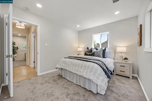 a bedroom with a bed and a lamp