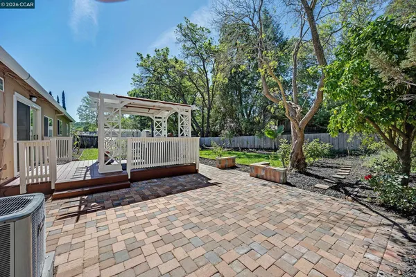 a view of a deck with a bench and some trees
