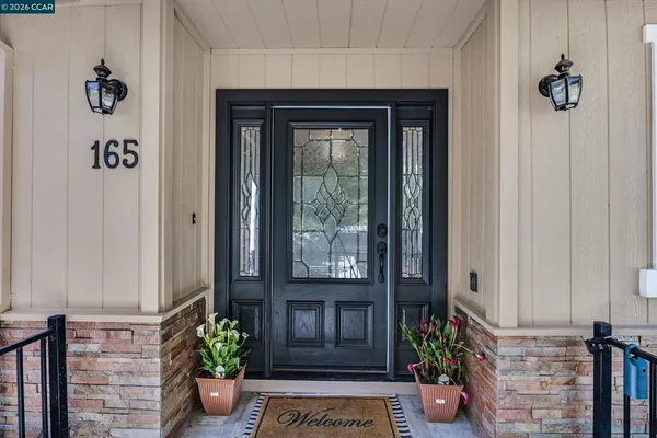 a front view of a house with a potted plant