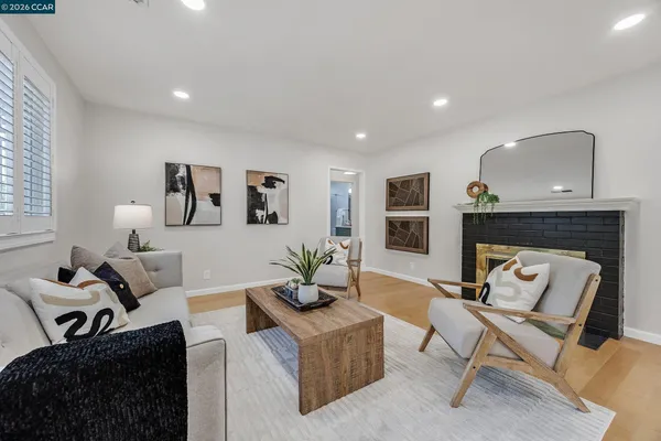 a living room with furniture and a fireplace