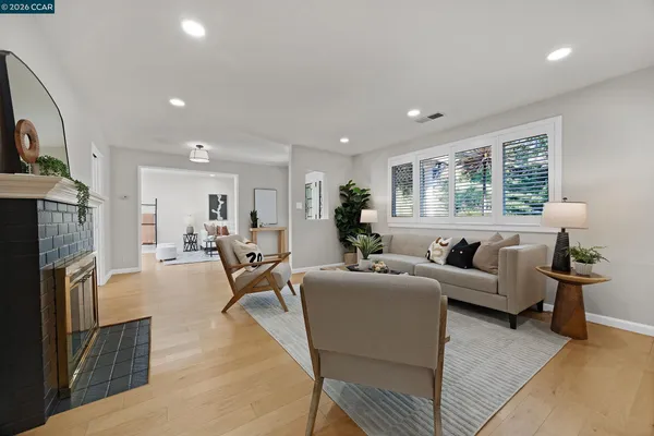 a living room with furniture a large window and a fireplace