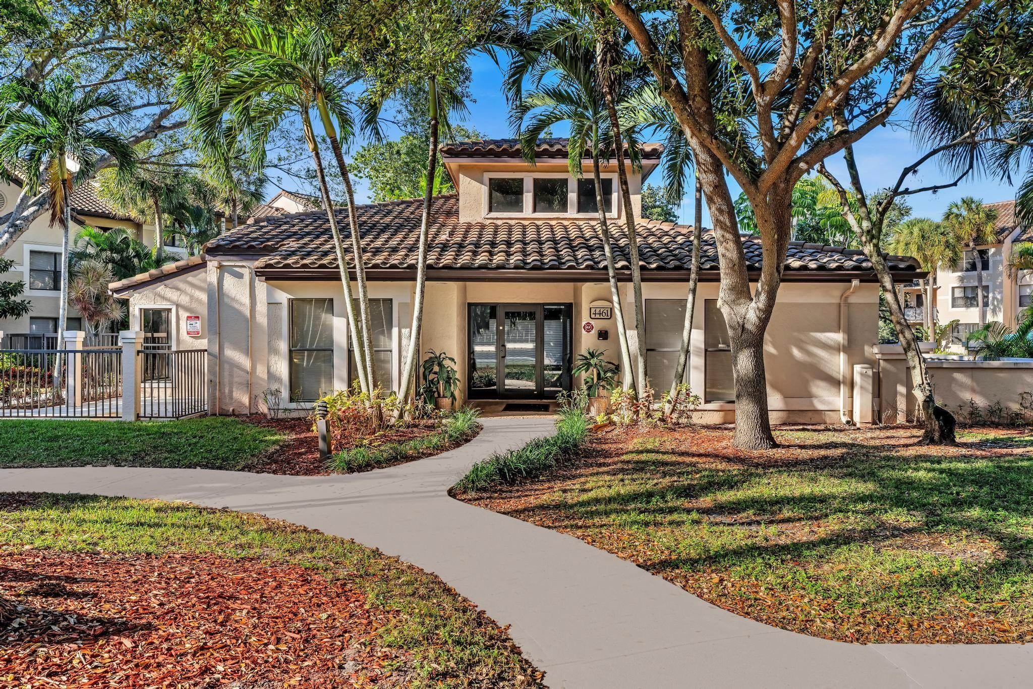 4481 West McNab Road, Unit 28 Pompano Beach, FL 33069 - Photo 1 of 45 a front view of a house with garden