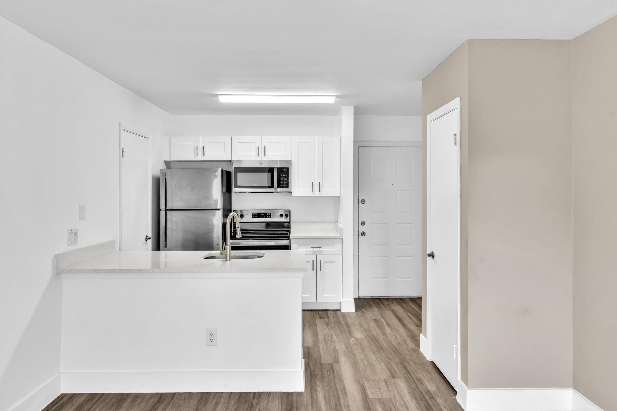 4481 West McNab Road, Unit 28 Pompano Beach, FL 33069 - Photo 11 of 45 a kitchen with stainless steel appliances a refrigerator and a stove top oven