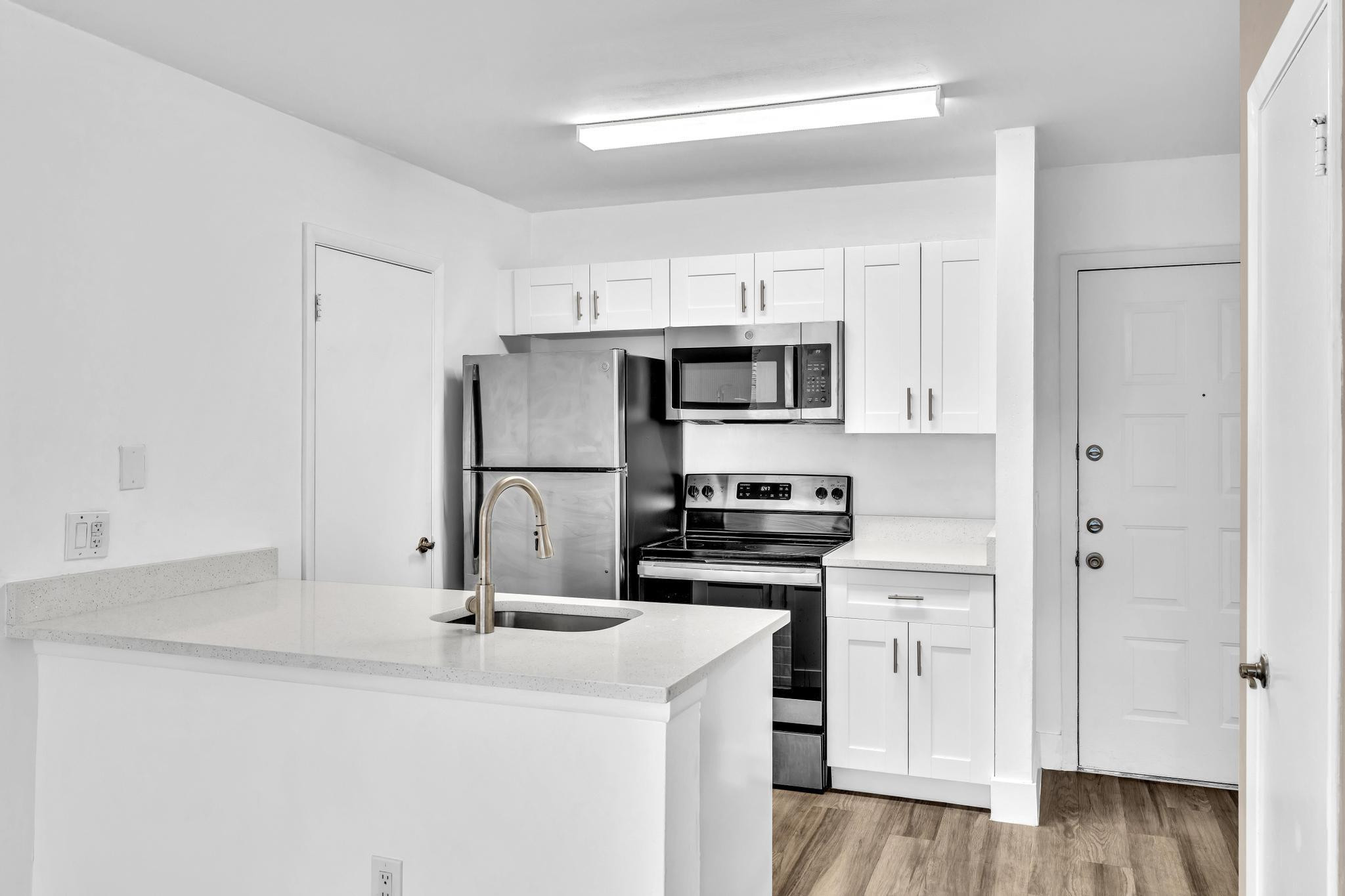 4481 West McNab Road, Unit 28 Pompano Beach, FL 33069 - Photo 13 of 45 a kitchen with kitchen island a sink stainless steel appliances and cabinets