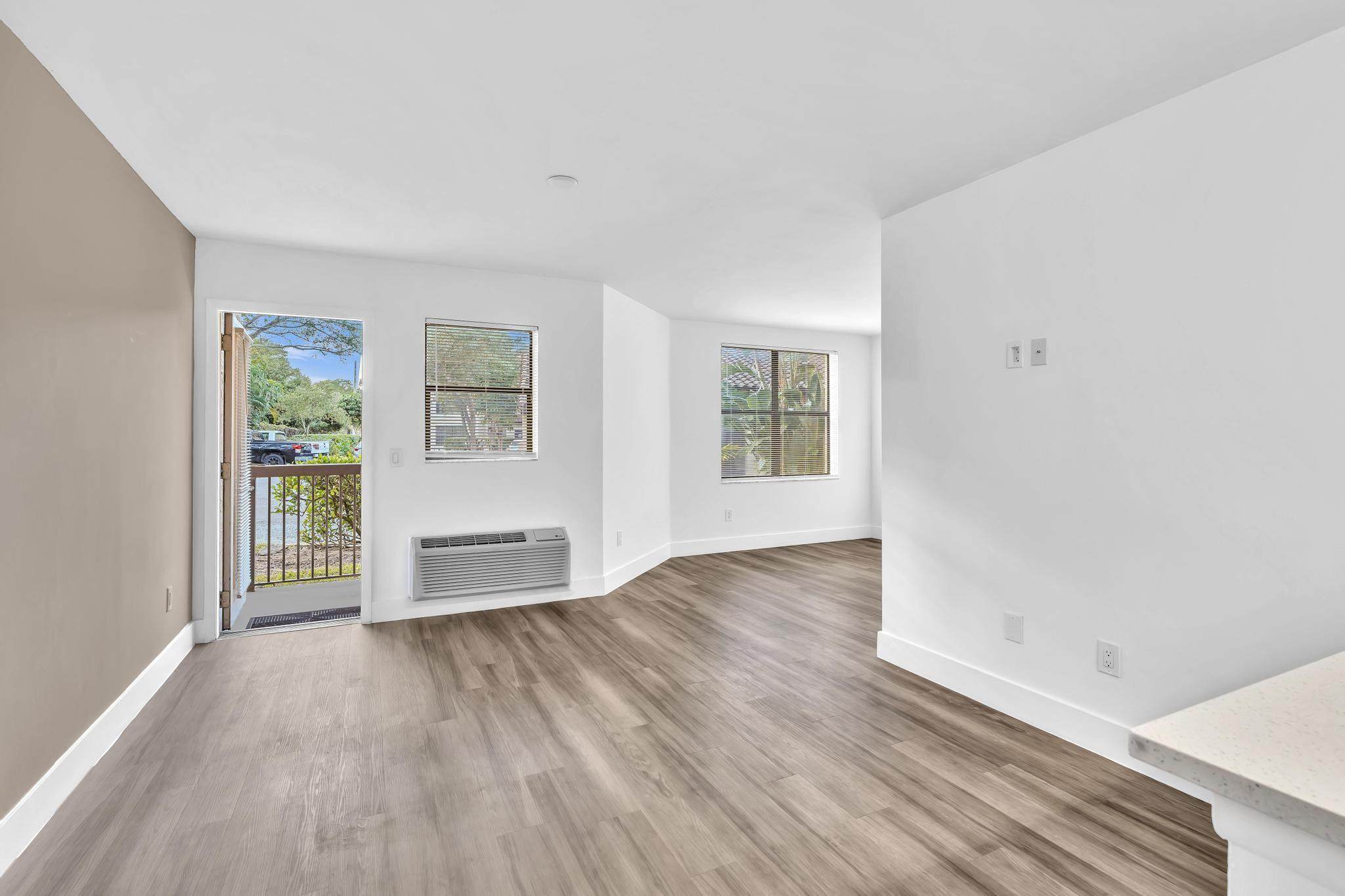 4481 West McNab Road, Unit 28 Pompano Beach, FL 33069 - Photo 15 of 45 an empty room with wooden floor and windows