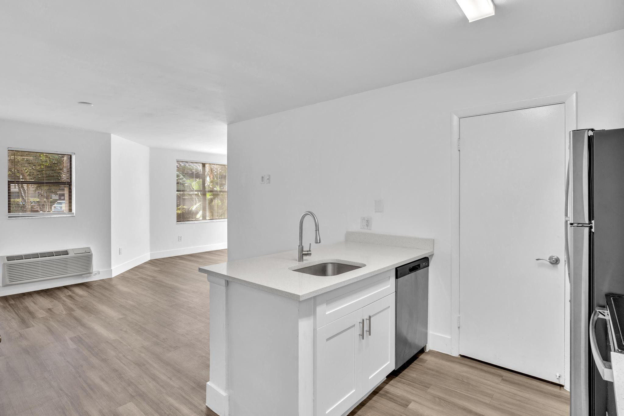 4481 West McNab Road, Unit 28 Pompano Beach, FL 33069 - Photo 4 of 45 a kitchen with a sink cabinets and wooden floor
