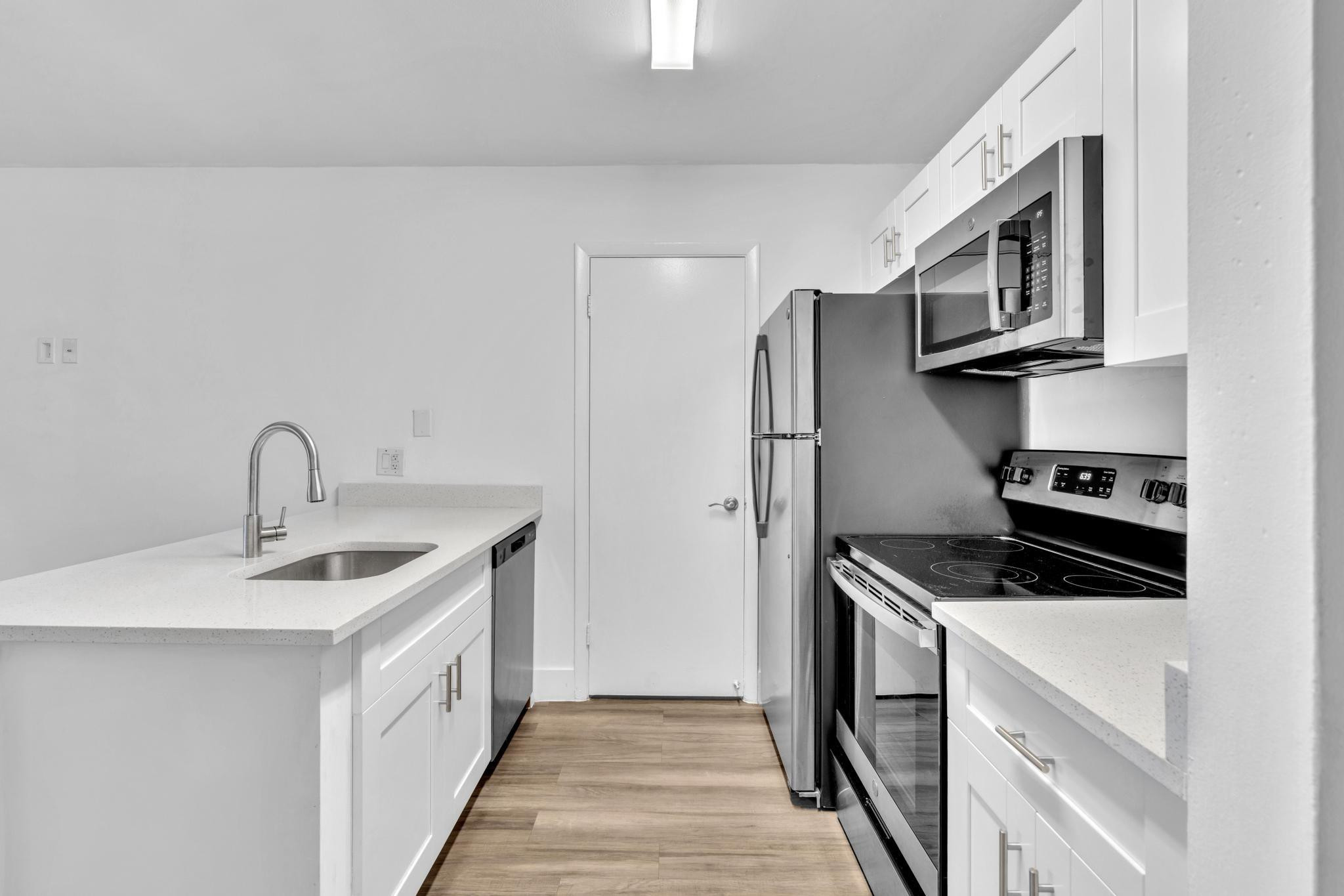 4481 West McNab Road, Unit 28 Pompano Beach, FL 33069 - Photo 6 of 45 a kitchen with stainless steel appliances granite countertop a sink stove and refrigerator