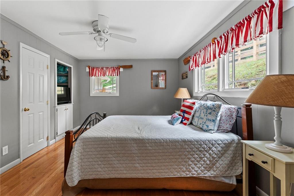 221 Reece Creek Road West Blairsville, GA 30512 - Photo 34 of 42 a bedroom with a large bed and a chandelier