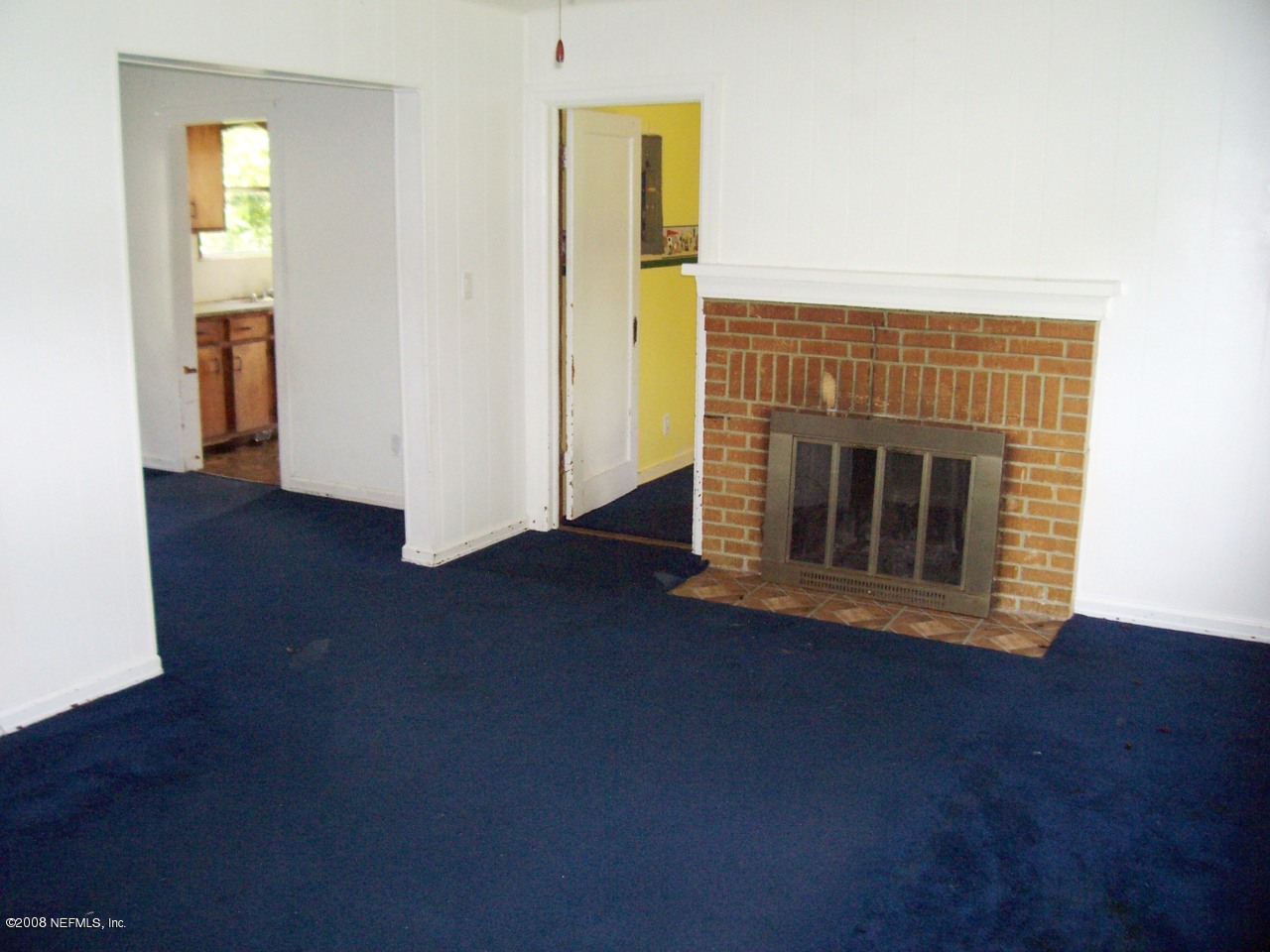 4609 Sunderland Road Jacksonville, FL 32210 - Photo 5 of 7 a view of empty room with wooden floor and fireplace