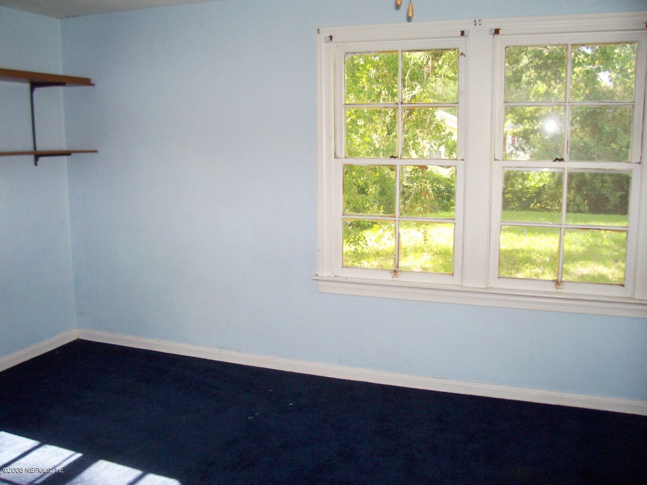 4609 Sunderland Road Jacksonville, FL 32210 - Photo 7 of 7 a view of an empty room with wooden floor and windows