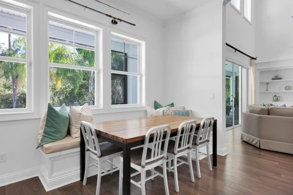 a view of a dining room with furniture and wooden floor
