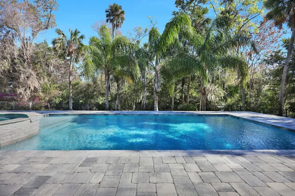 an aerial view of a city with lots of residential buildings ocean and mountain view in back