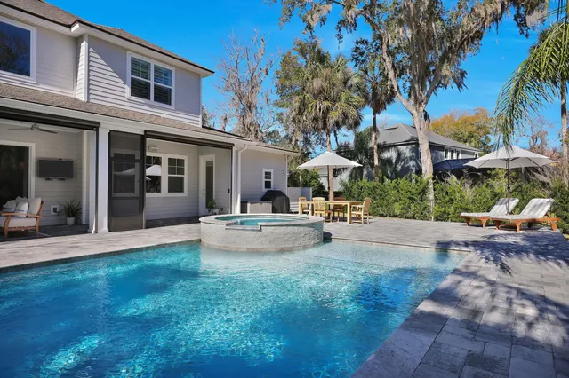 a front view of a white house with a yard