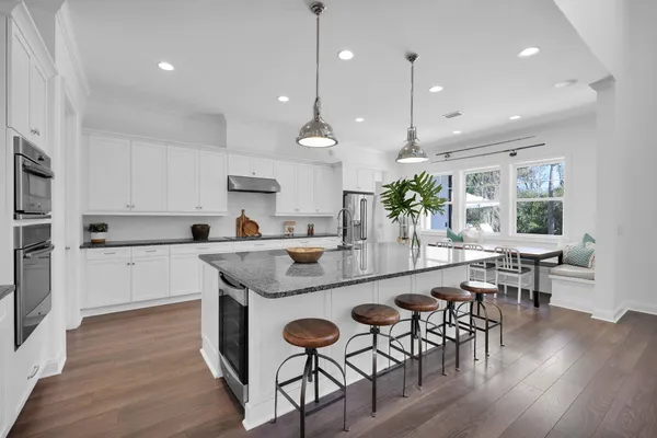 a kitchen with stainless steel appliances granite countertop counter space and wooden floor