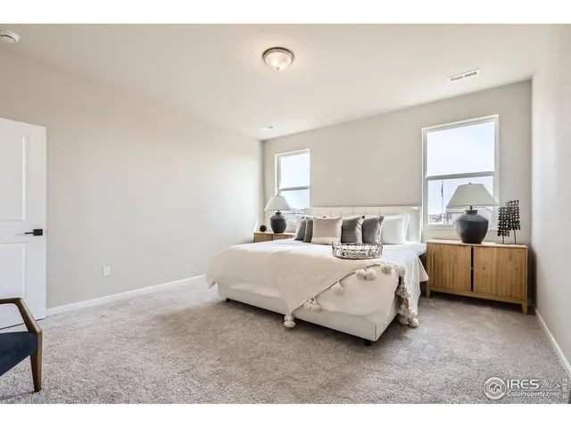a living room with a bed furniture and a window