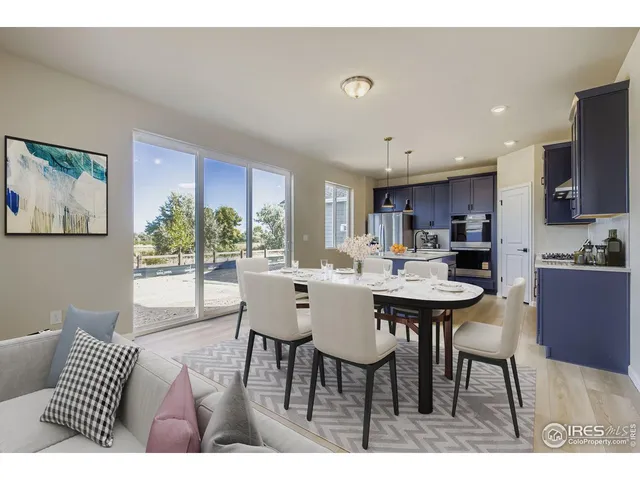 a kitchen with a sink a counter top space and living room view