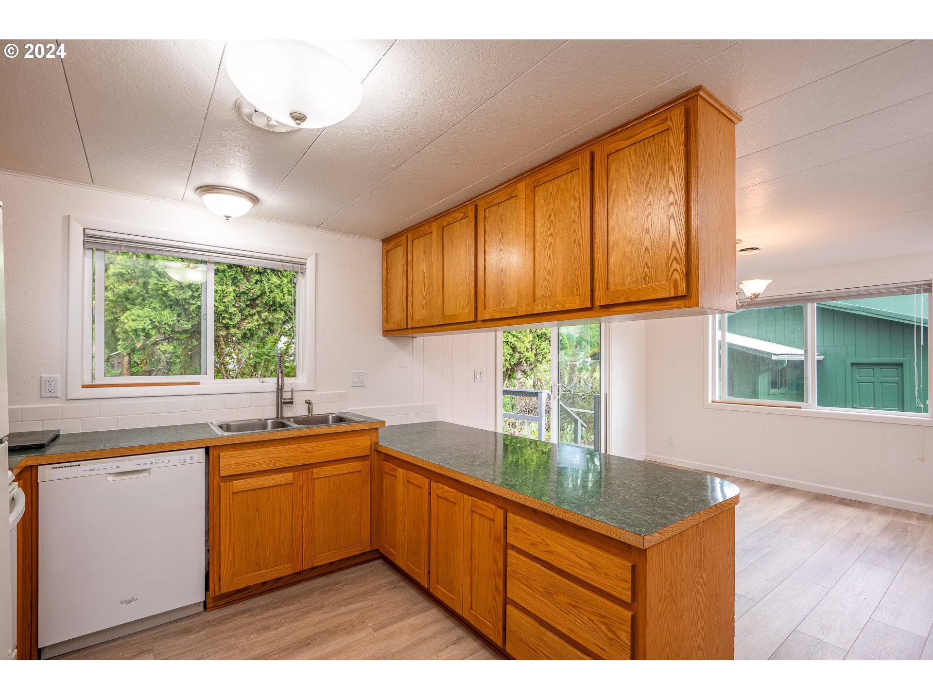 88439 Stephens Road Springfield, OR 97478 - Photo 11 of 30 a kitchen with a sink a window and cabinets