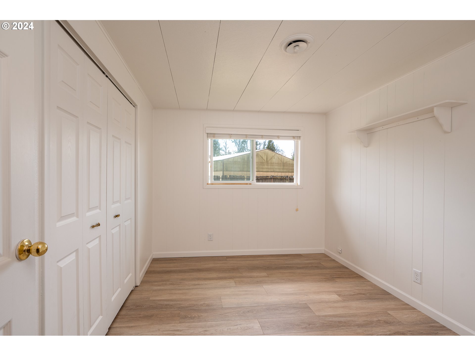 88439 Stephens Road Springfield, OR 97478 - Photo 12 of 30 a view of an empty room with wooden floor and a window