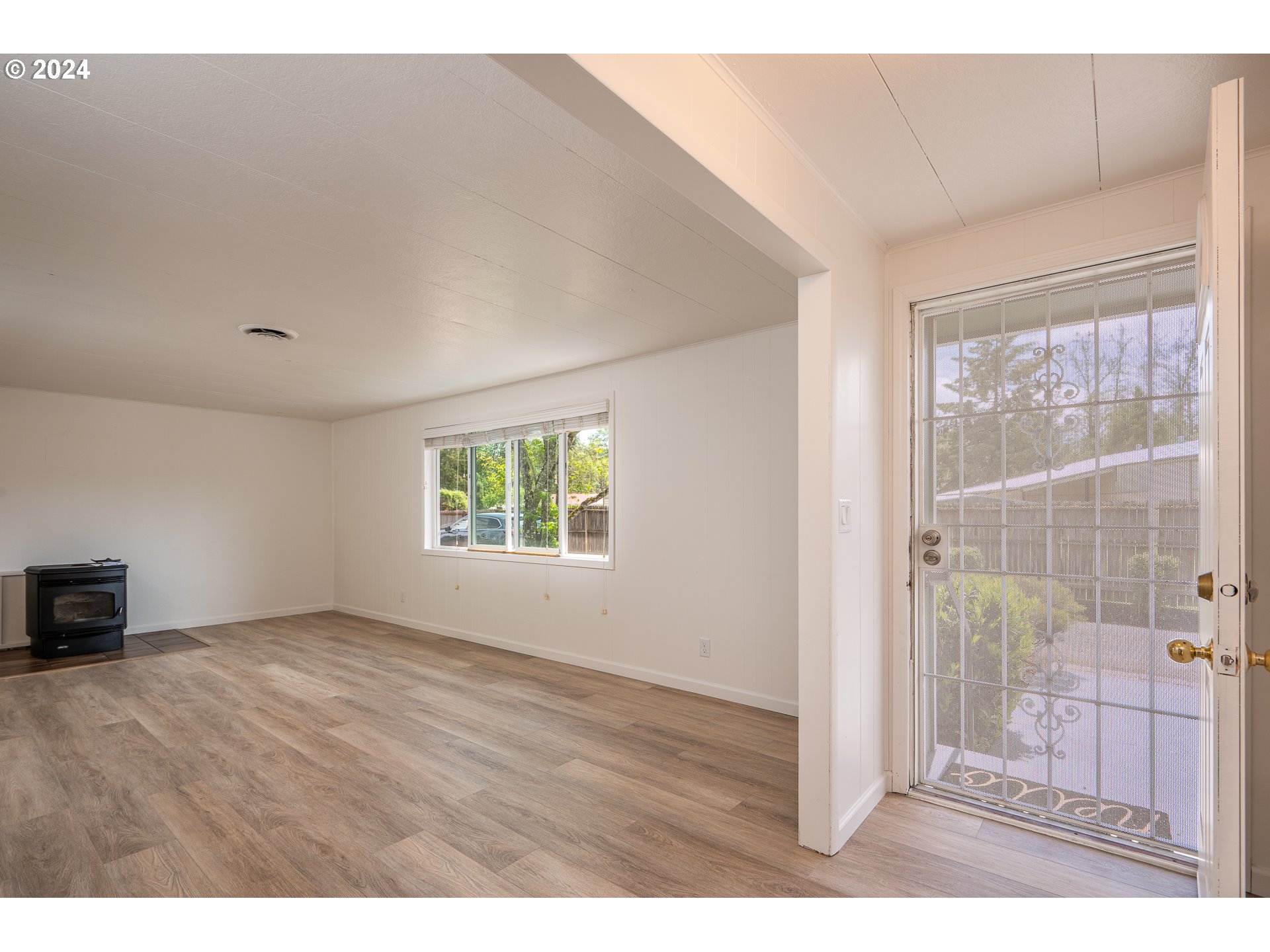 88439 Stephens Road Springfield, OR 97478 - Photo 3 of 30 a view of an empty room with wooden floor and a window