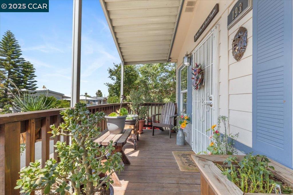 a view of balcony with chairs and potted plants
