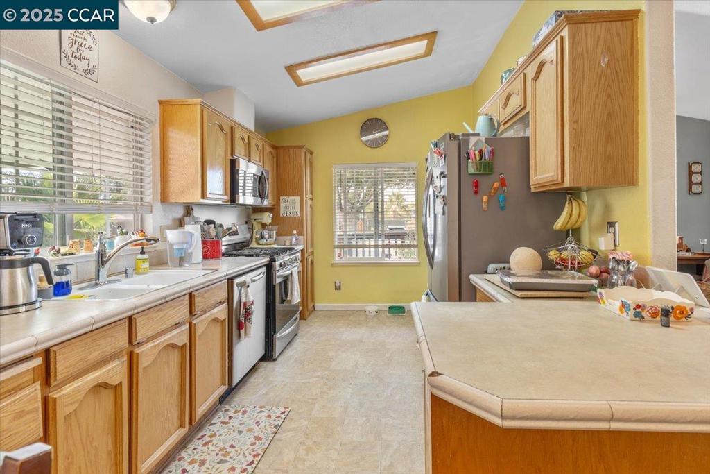193 Maureen Circle Bay Point, CA 94565 - Photo 12 of 27 a kitchen with stainless steel appliances granite countertop a sink and cabinets
