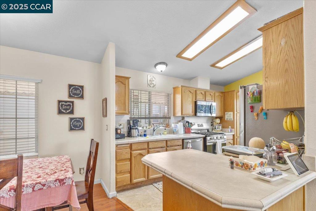 193 Maureen Circle Bay Point, CA 94565 - Photo 14 of 27 a kitchen with stainless steel appliances kitchen island granite countertop a sink and a refrigerator