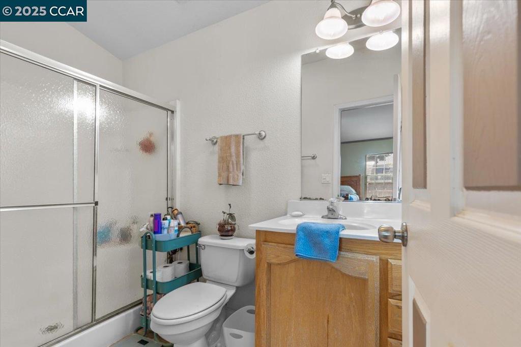 193 Maureen Circle Bay Point, CA 94565 - Photo 18 of 27 a bathroom with a sink vanity mirror and toilet