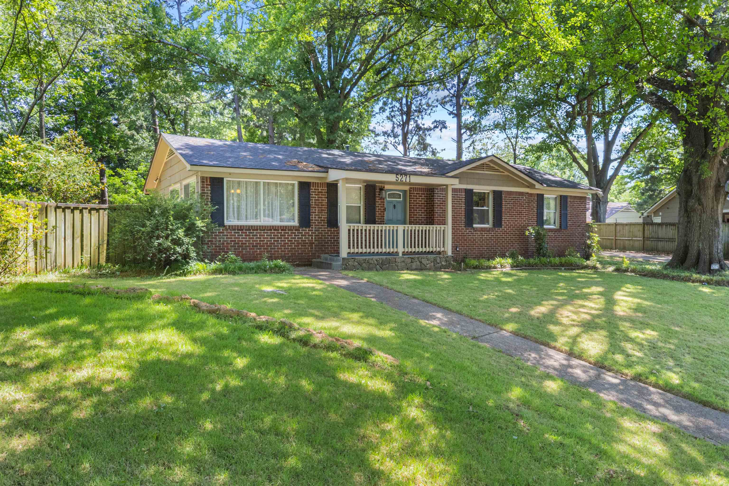 5271 Princeton Road Memphis, TN 38120 - Photo 10 of 30 Brick-front residence featuring a covered front porch with white railing, a light blue entry door, and dark shutters
