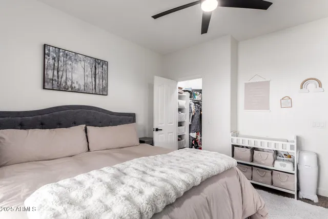 a bedroom with a large bed and a chandelier