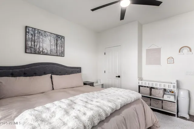 a bedroom with a bed and a painting on the wall