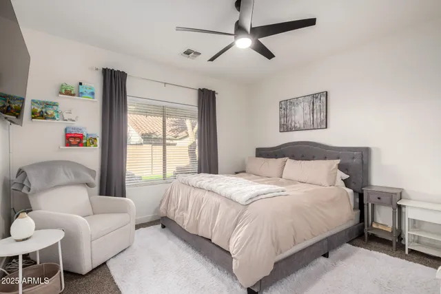 a bedroom with a bed and a couch