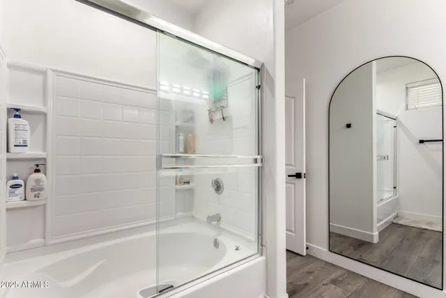 a bathroom with a bathtub and a shower