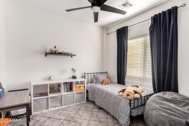 a bedroom with a bed and a window