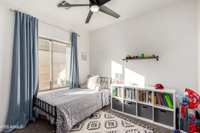 a bedroom with bed and a book shelf